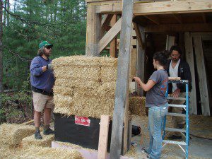 People Stacking Straw Bale Walls on Edge