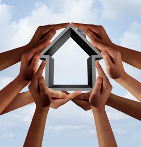 Social housing and affordable community property as a group of diverse hands holding a family house symbol with 3D illustration elements.